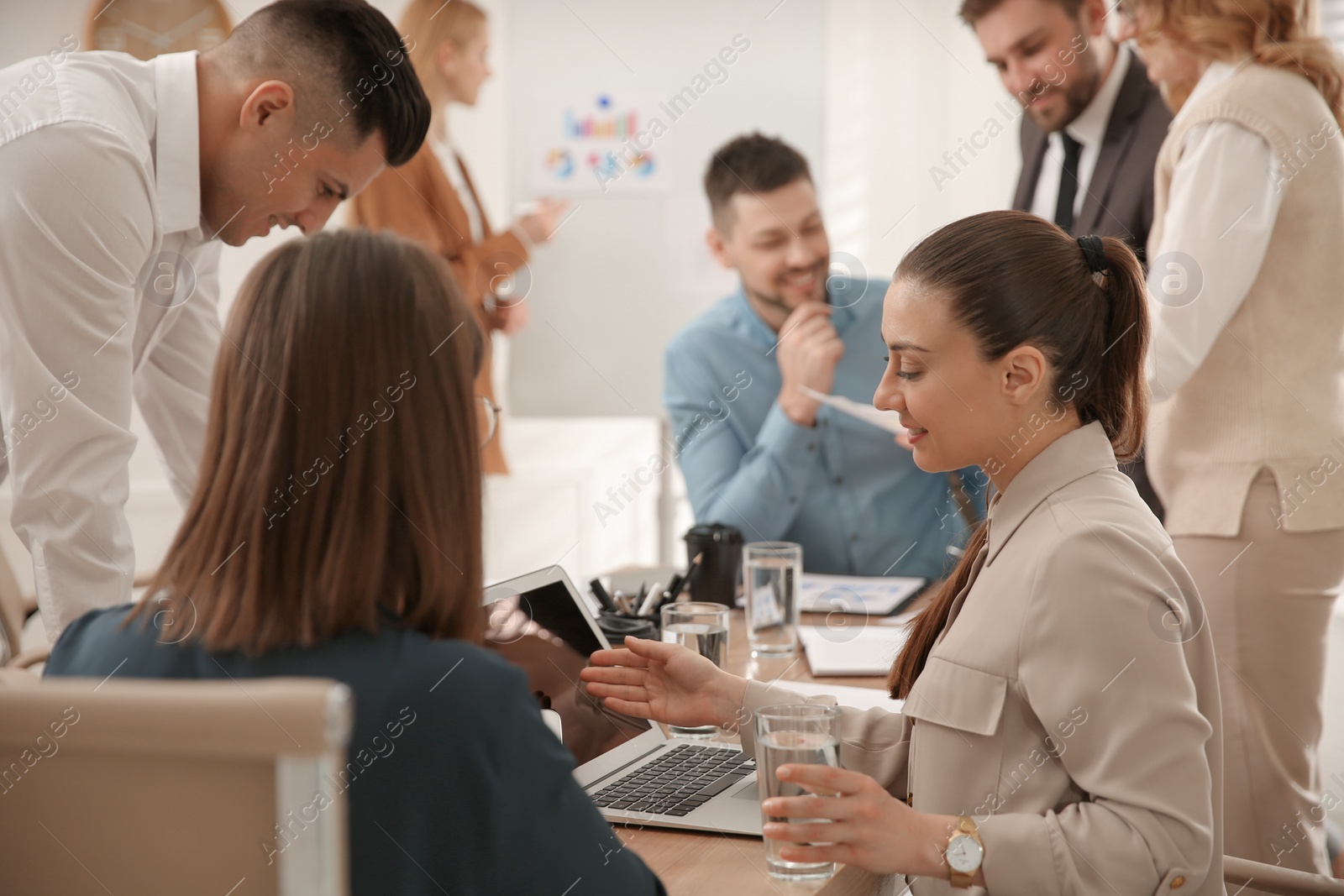 Photo of Businesspeople having meeting in office. Management consulting