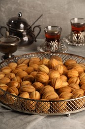 Delicious walnut shaped cookies and tea on grey table. Tasty pastry carrying nostalgic home atmosphere