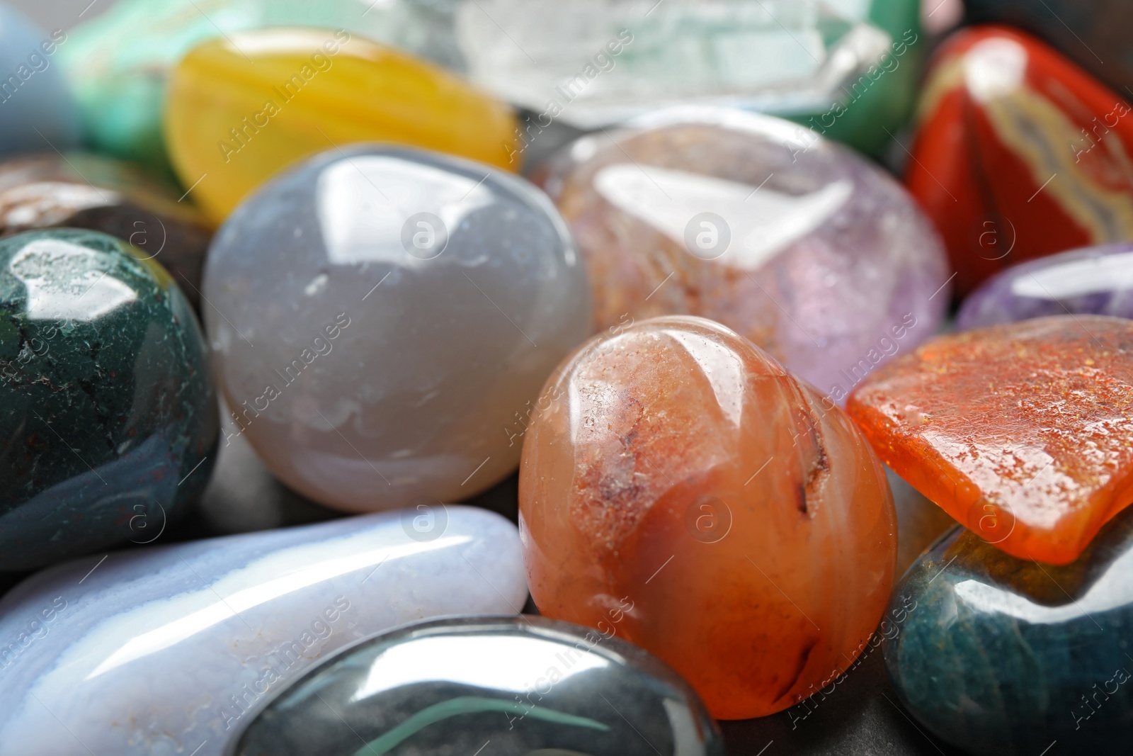 Photo of Different precious gemstones as background, closeup view