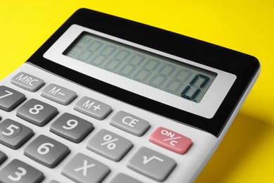 Photo of Calculator on yellow background, closeup. Office equipment