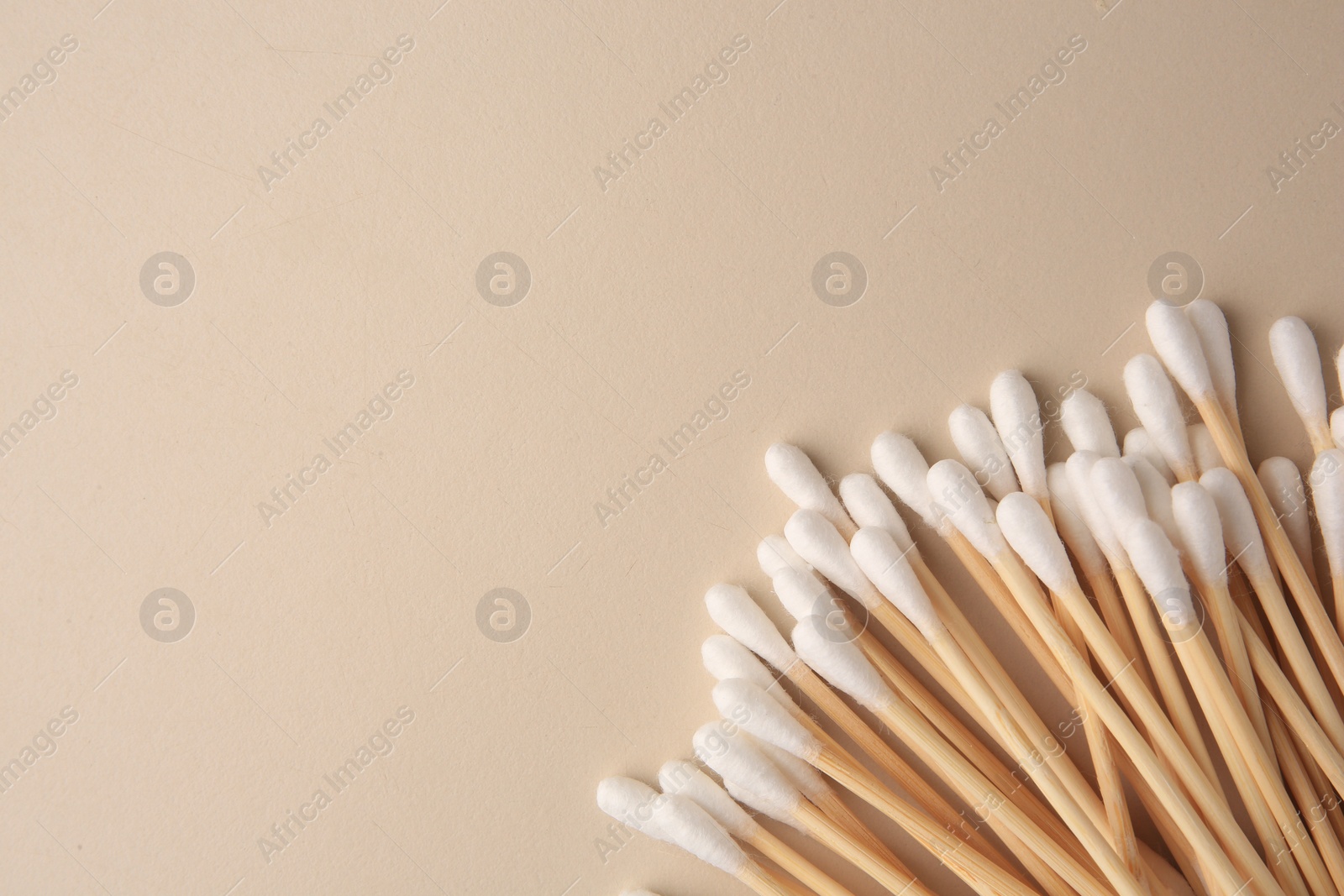 Photo of Many clean cotton buds on beige background, flat lay. Space for text