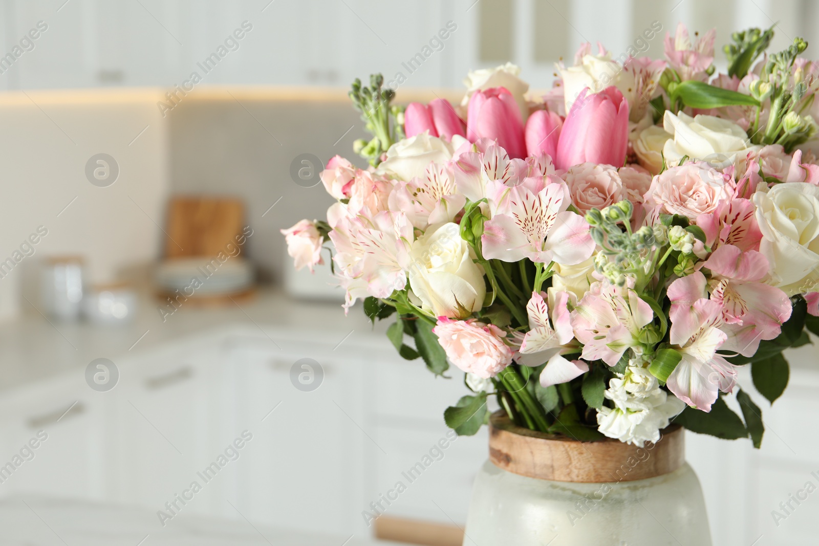 Photo of Beautiful bouquet of fresh flowers in vase indoors