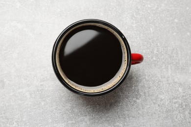 Photo of Cup of aromatic coffee on light grey table, top view