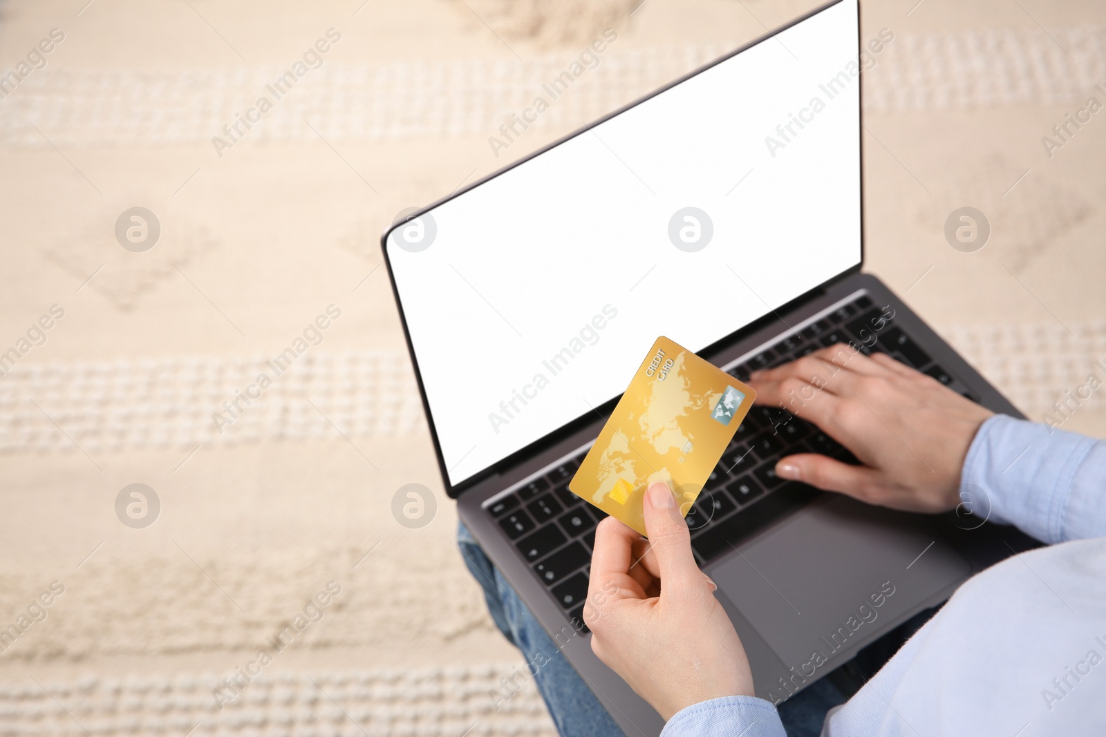 Photo of Online payment. Woman using credit card and laptop with blank screen, above view. Space for text