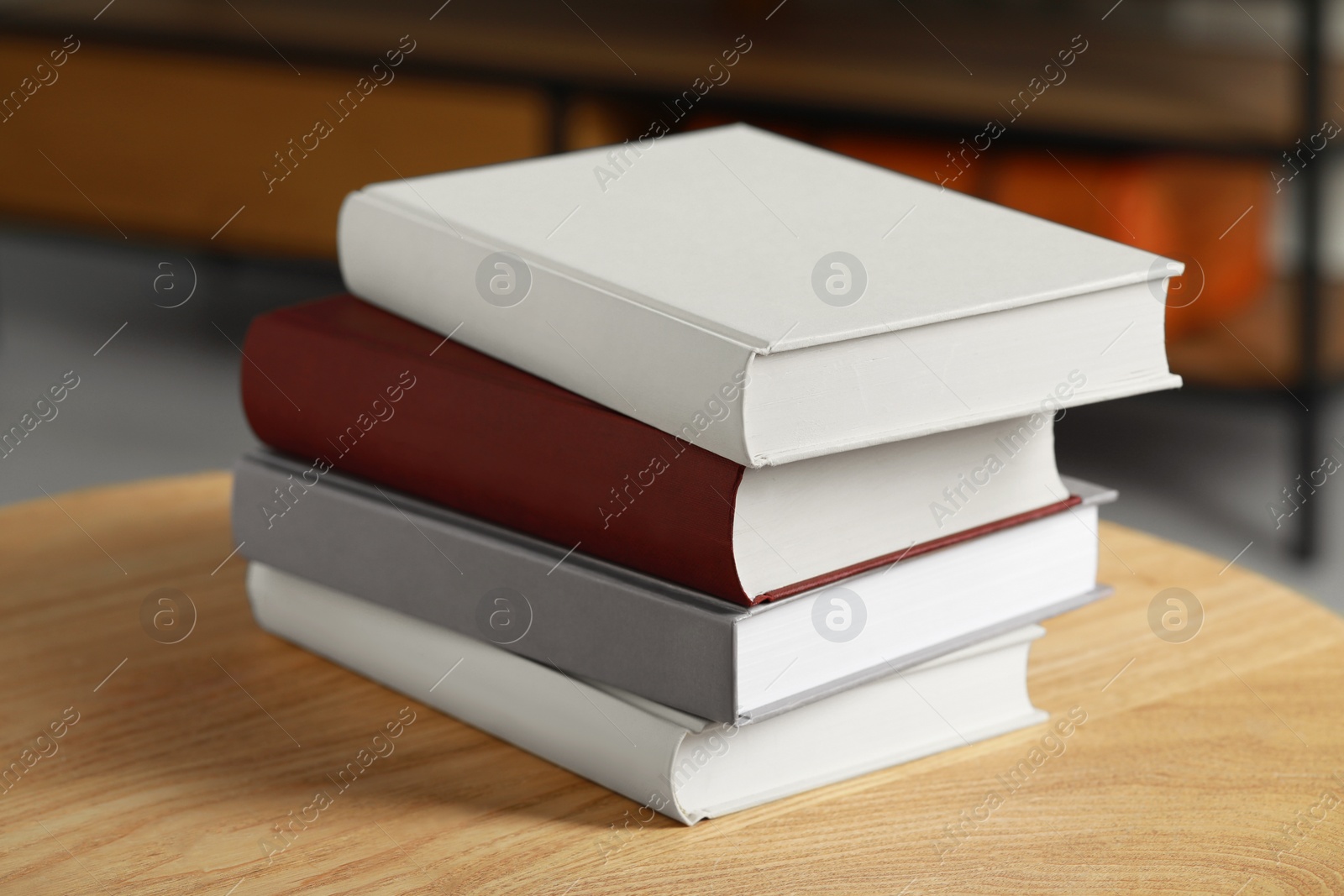 Photo of Many books stacked on wooden table indoors