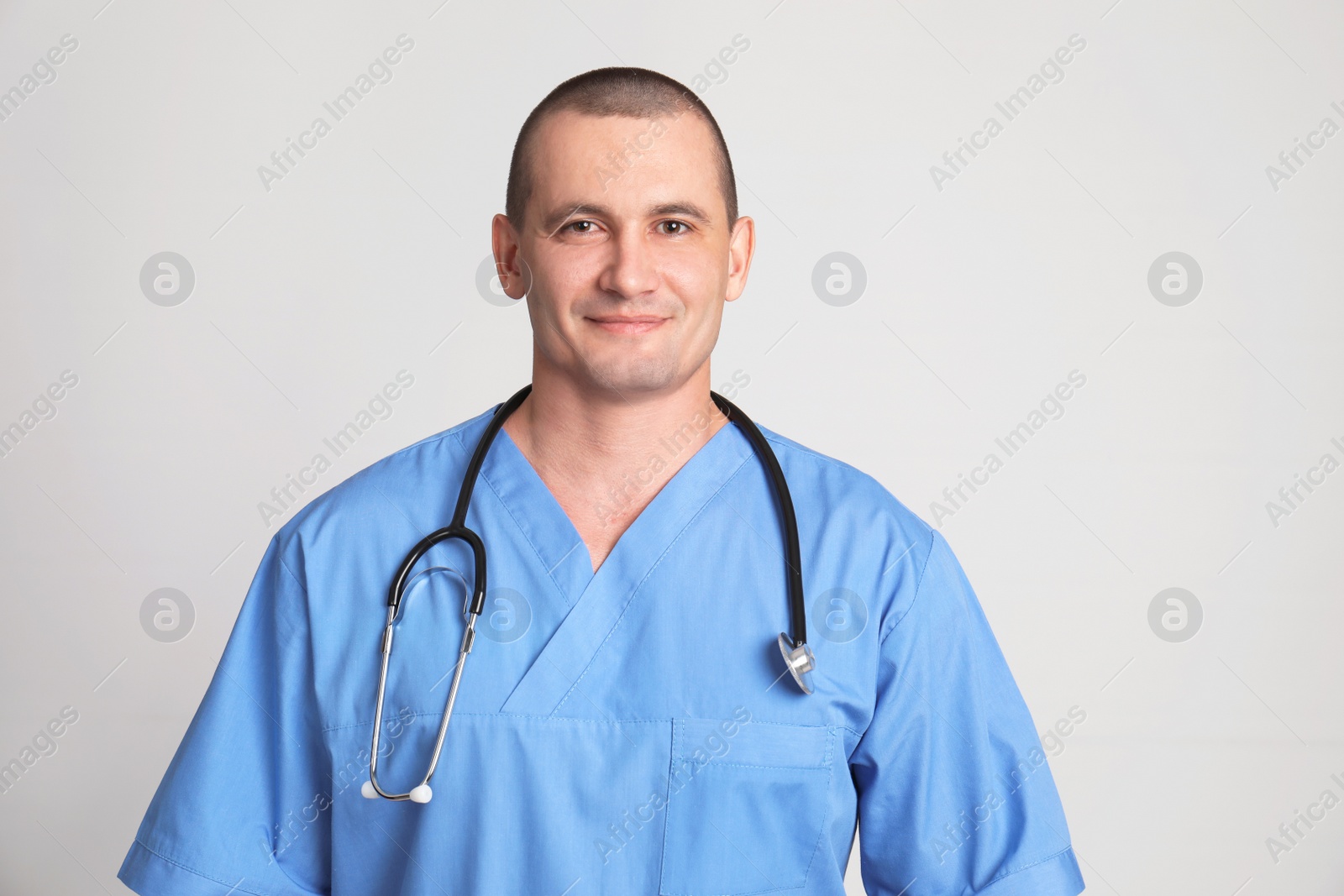 Photo of Portrait of medical assistant with stethoscope on color background