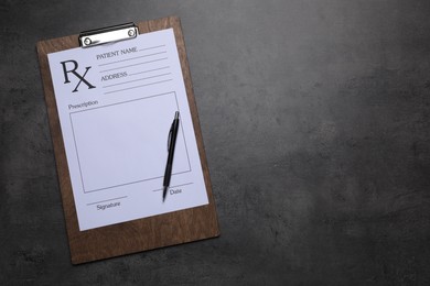Photo of Clipboard with medical prescription form and pen on dark grey table, top view. Space for text