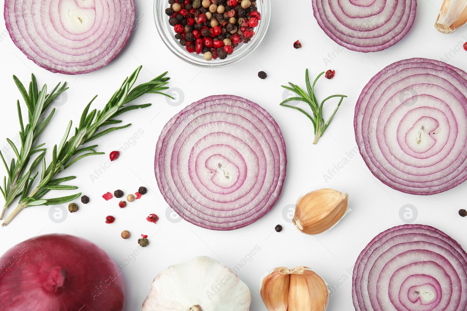 Photo of Fresh red onions, garlic, rosemary and spices on white background, flat lay