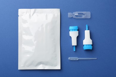 Photo of Disposable express test kit on blue background, flat lay