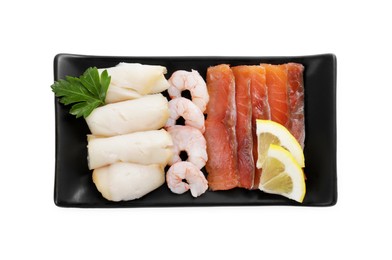 Photo of Sashimi set (raw slices of salmon, oily fish and shrimps) served with lemon and parsley isolated on white, top view