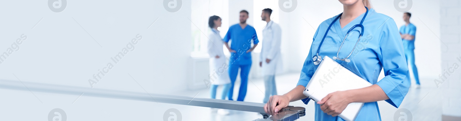 Image of Doctor in uniform with tablet at workplace, space for text. Banner design
