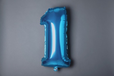 Photo of Blue number one balloon on grey background