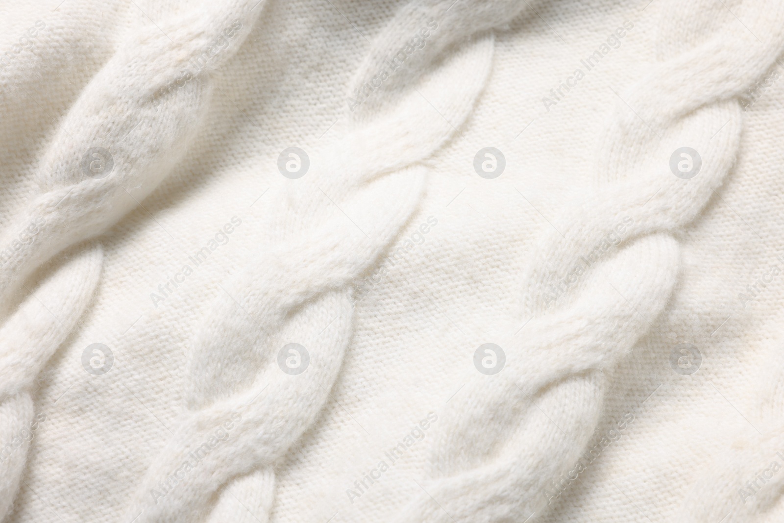 Photo of Texture of soft white knitted fabric as background, top view