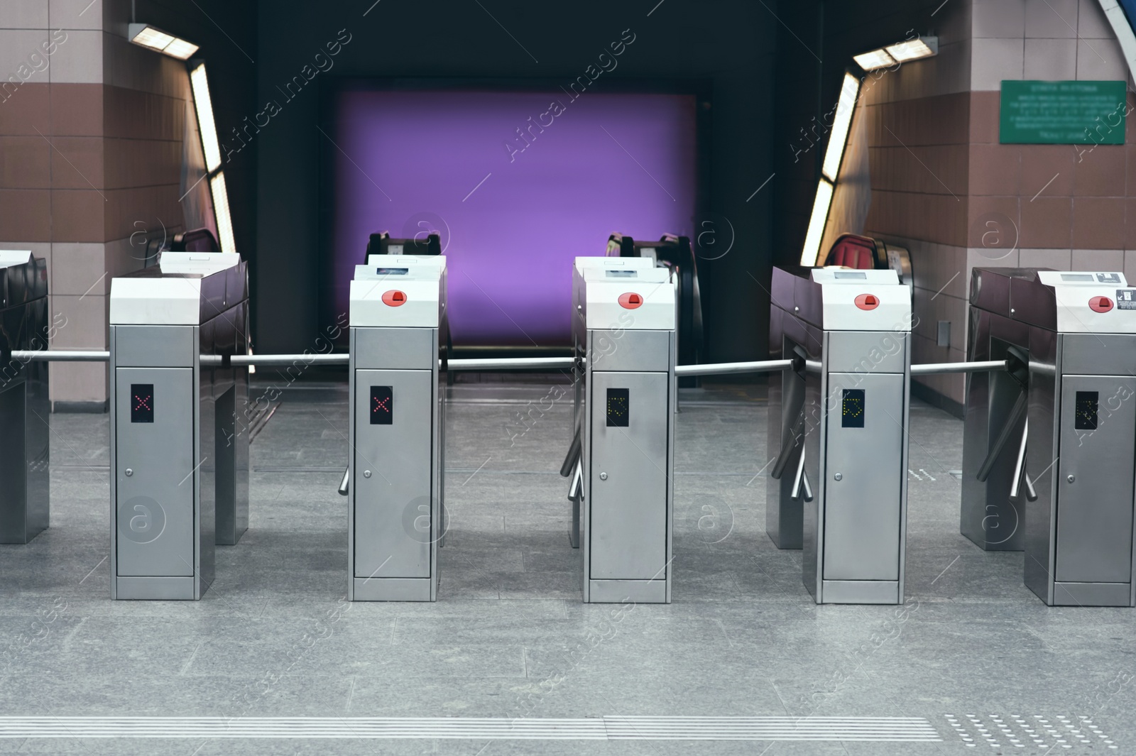 Photo of Many modern turnstiles outdoors. Fare collection system