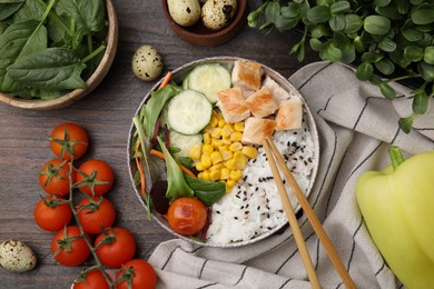 Photo of Delicious poke bowl and ingredients on wooden table, flat lay