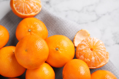 Photo of Fresh ripe tangerines on white marble table, top view
