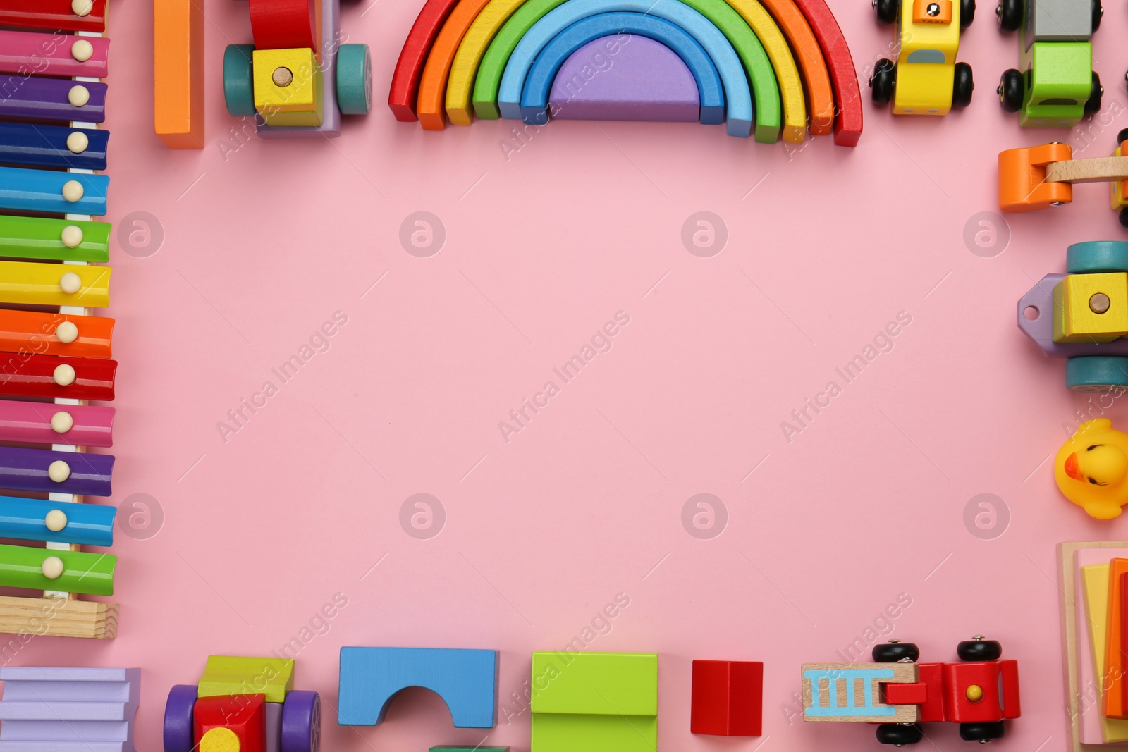 Photo of Frame of different children's toys on pink background, flat lay. Space for text