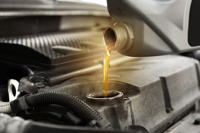 Image of Pouring motor oil into car engine, closeup. Color accent effect