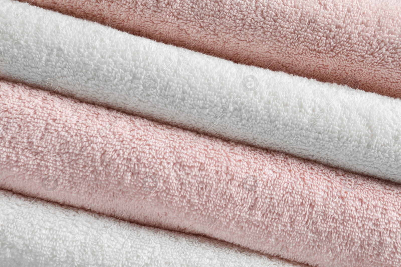 Photo of Stack of fresh soft towels as background