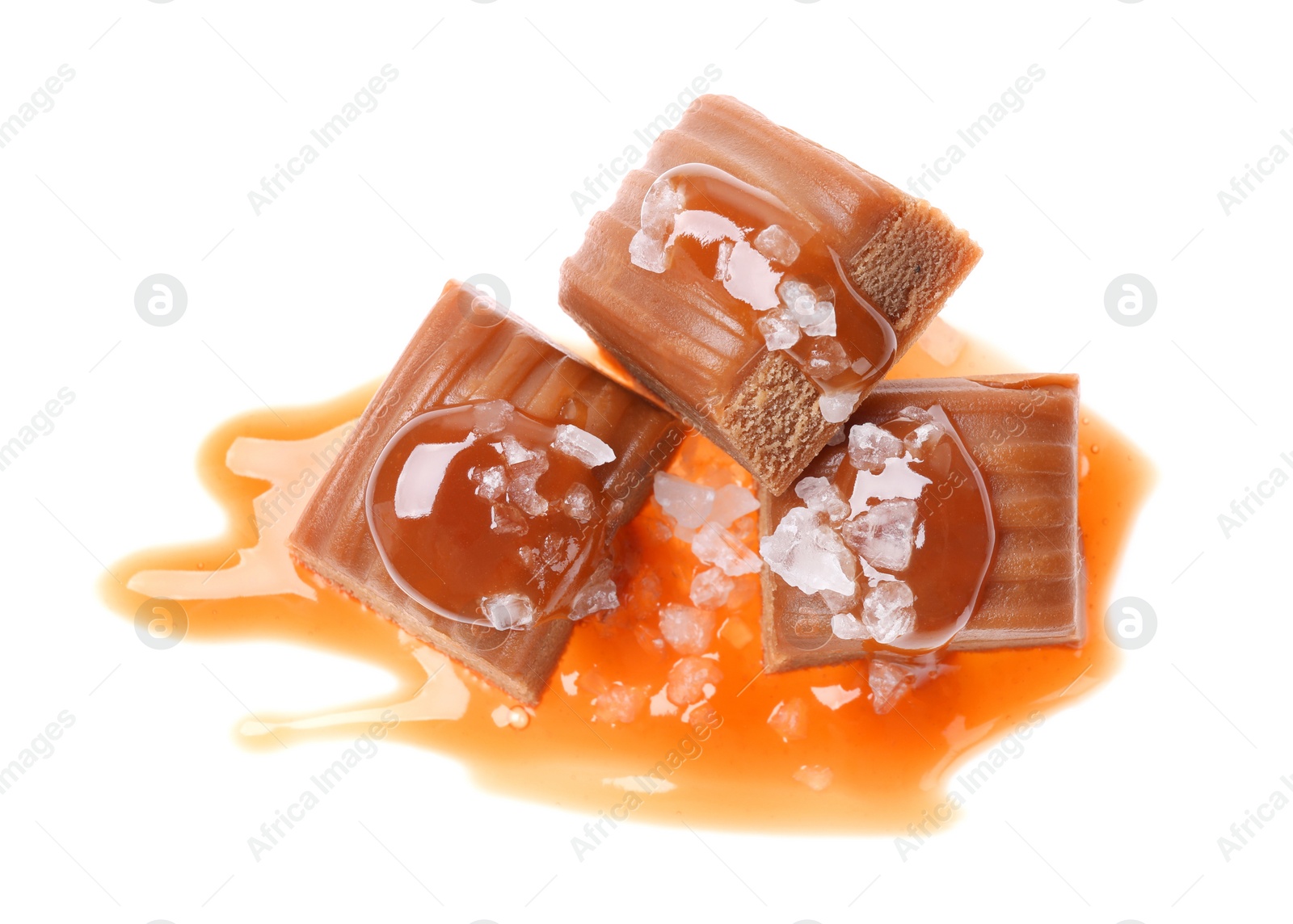 Photo of Delicious salted caramel with sauce on white background, top view