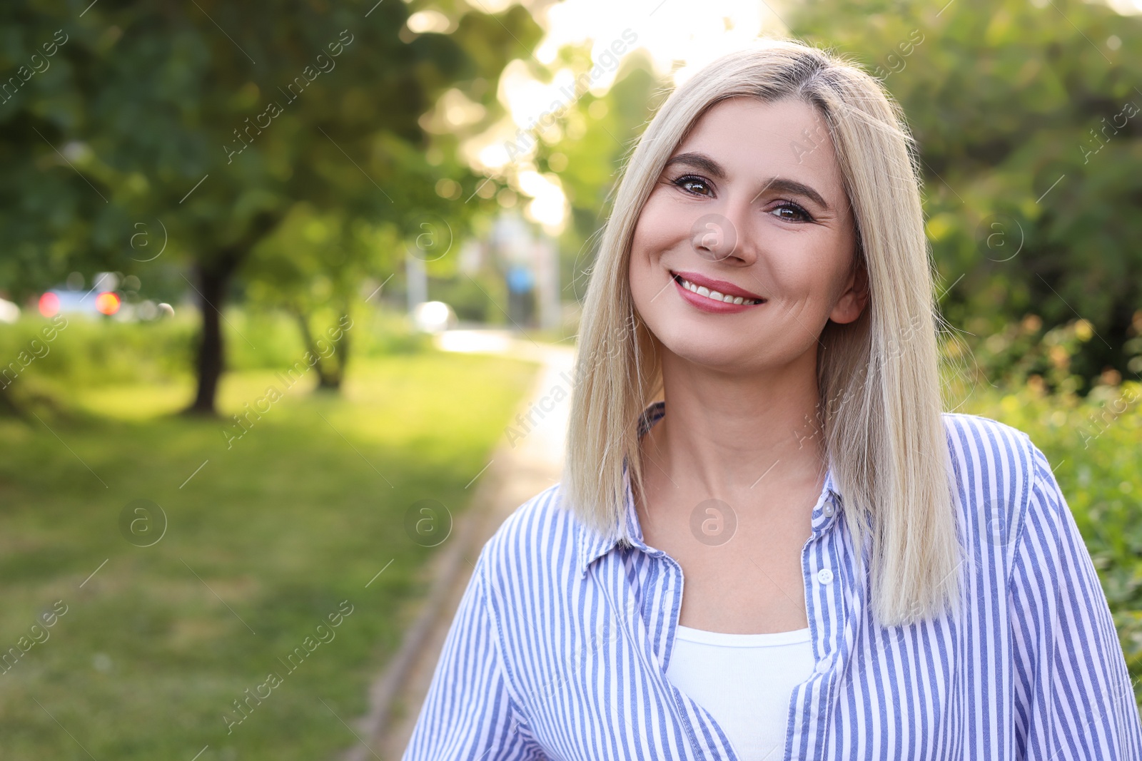 Photo of Portrait of beautiful woman outdoors on sunny day, space for text