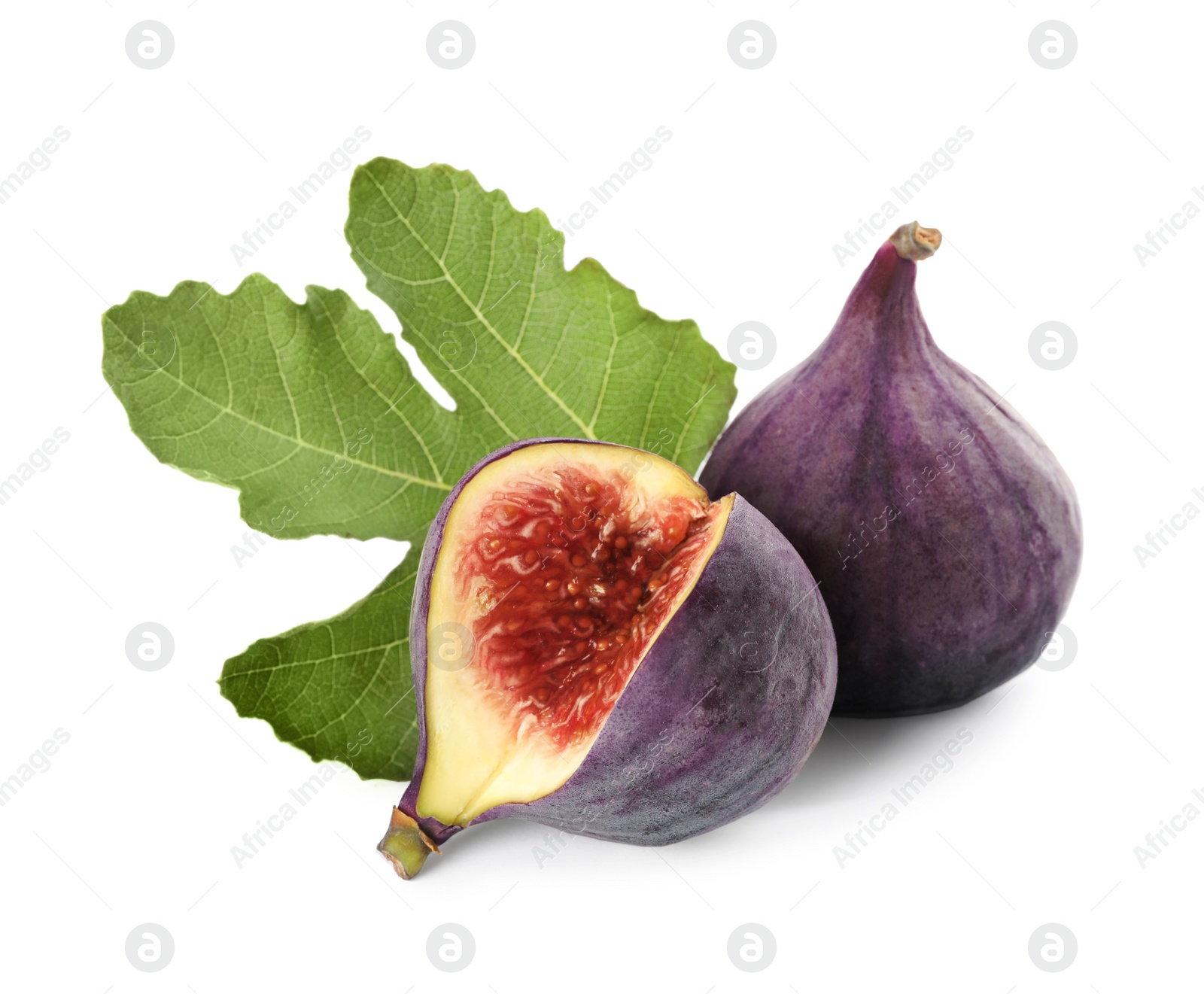 Photo of Tasty whole and cut figs with green leaf isolated on white