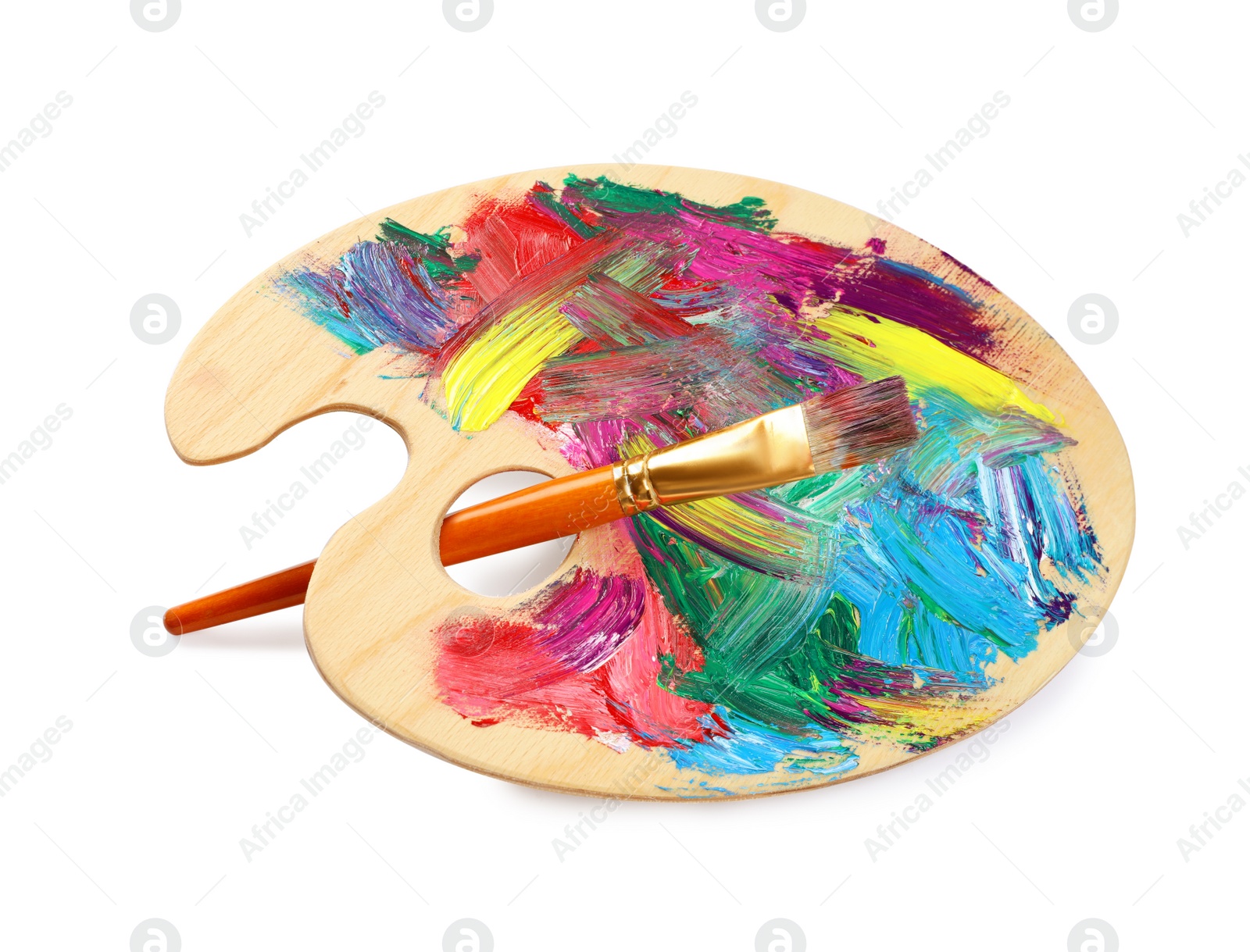 Photo of Wooden artist's palette with mixed paints and brush isolated on white