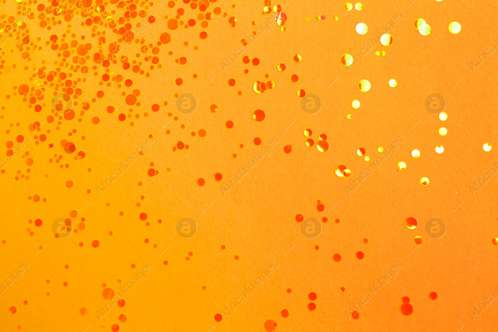 Photo of Shiny bright yellow glitter on beige background, flat lay