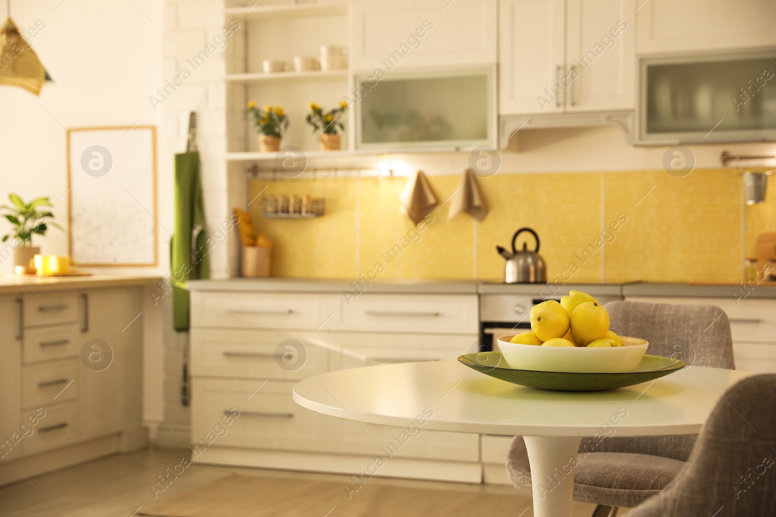 Photo of White table in modern kitchen interior. Space for text