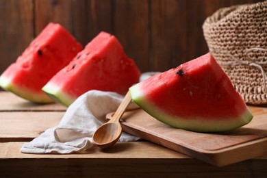 Sliced fresh juicy watermelon on wooden table, space for text