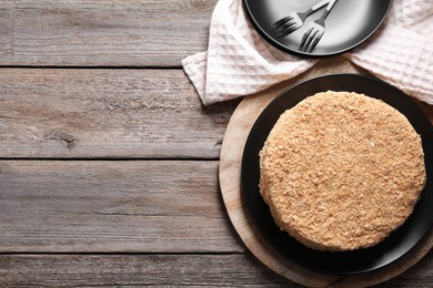 Delicious Napoleon cake on wooden table, top view. Space for text