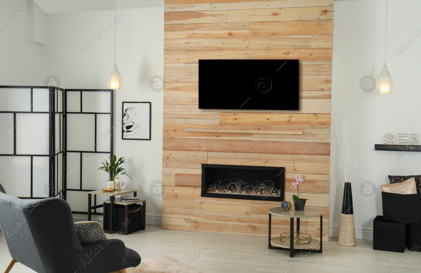 Photo of Living room interior with decorative fireplace in wooden wall