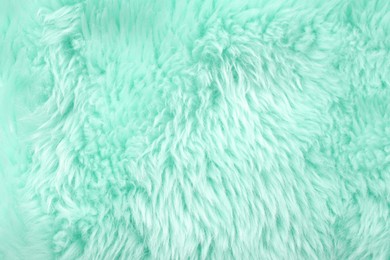 Texture of turquoise faux fur as background, closeup