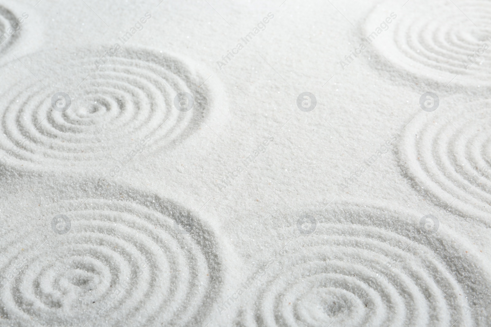 Photo of Zen rock garden. Circle patterns on white sand