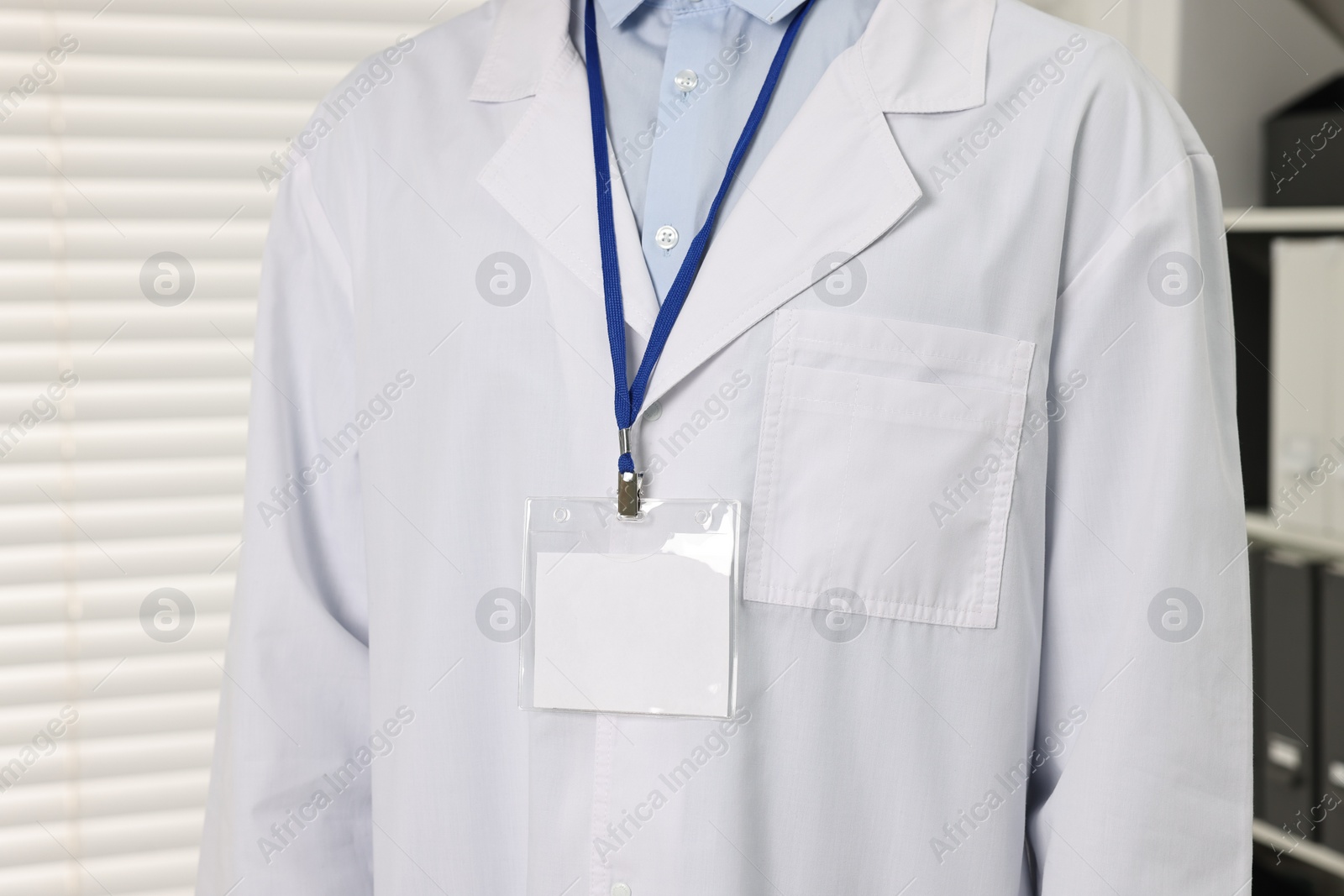 Photo of Doctor with empty badge in hospital, closeup