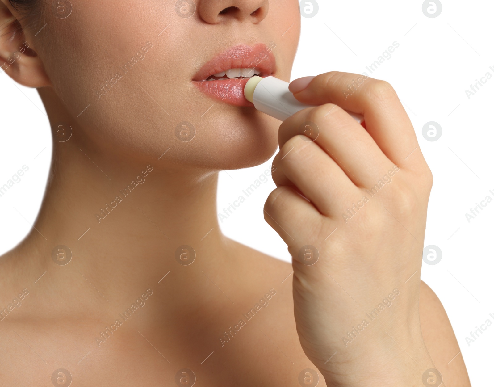 Photo of Young woman applying lip balm on white background, closeup