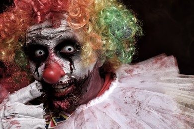 Photo of Portraitterrifying clown, closeup. Halloween party costume