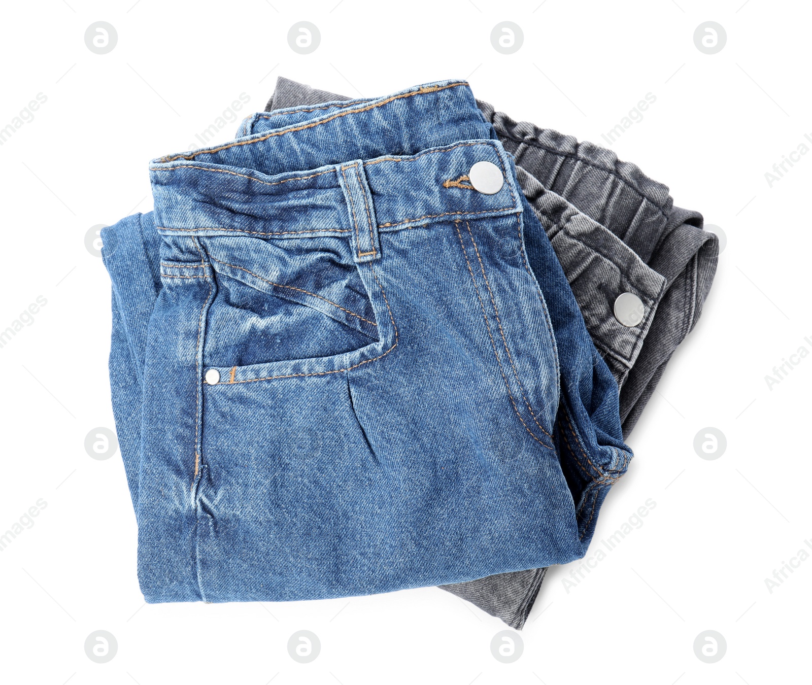 Photo of Stack of folded jeans on white background, top view