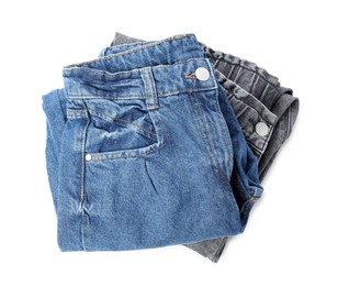 Photo of Stack of folded jeans on white background, top view