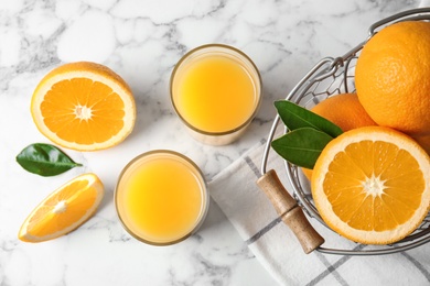 Flat lay composition with orange juice and fresh fruit on marble background