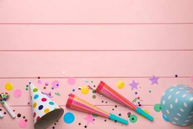 Photo of Flat lay composition with party items on pink wooden table, space for text