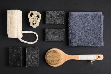 Photo of Flat lay composition with natural tar soap on black background