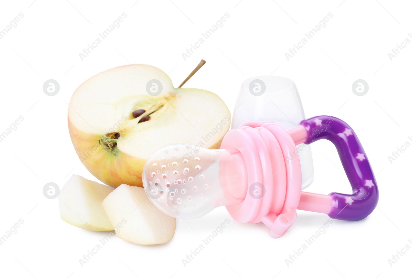 Photo of Empty nibbler and cut apple on white background. Baby feeder