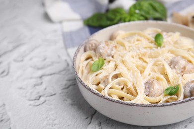 Photo of Delicious pasta with mushrooms and cheese on light grey textured background, closeup