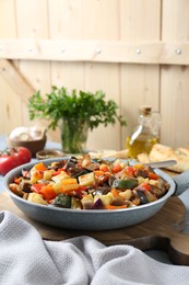 Photo of Delicious ratatouille in frying pan on table, space for text