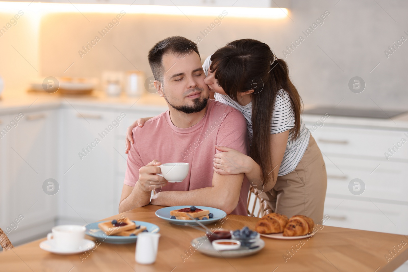 Photo of Lovely couple spending time together during breakfast at home