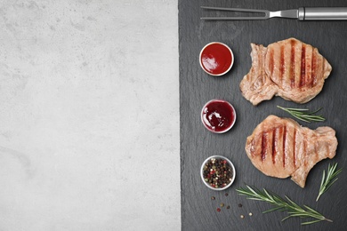 Photo of Flat lay composition with grilled meat on slate plate, space for text