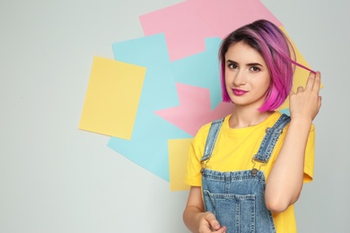 Photo of Young woman with trendy hairstyle against color background