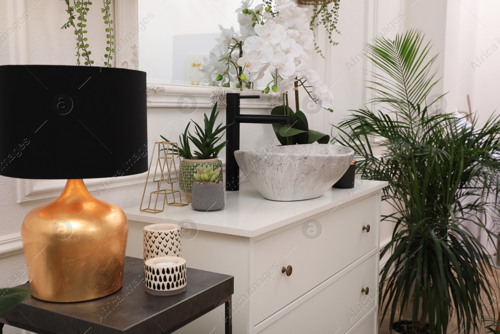 Photo of Stylish bathroom interior with modern furniture and beautiful houseplants