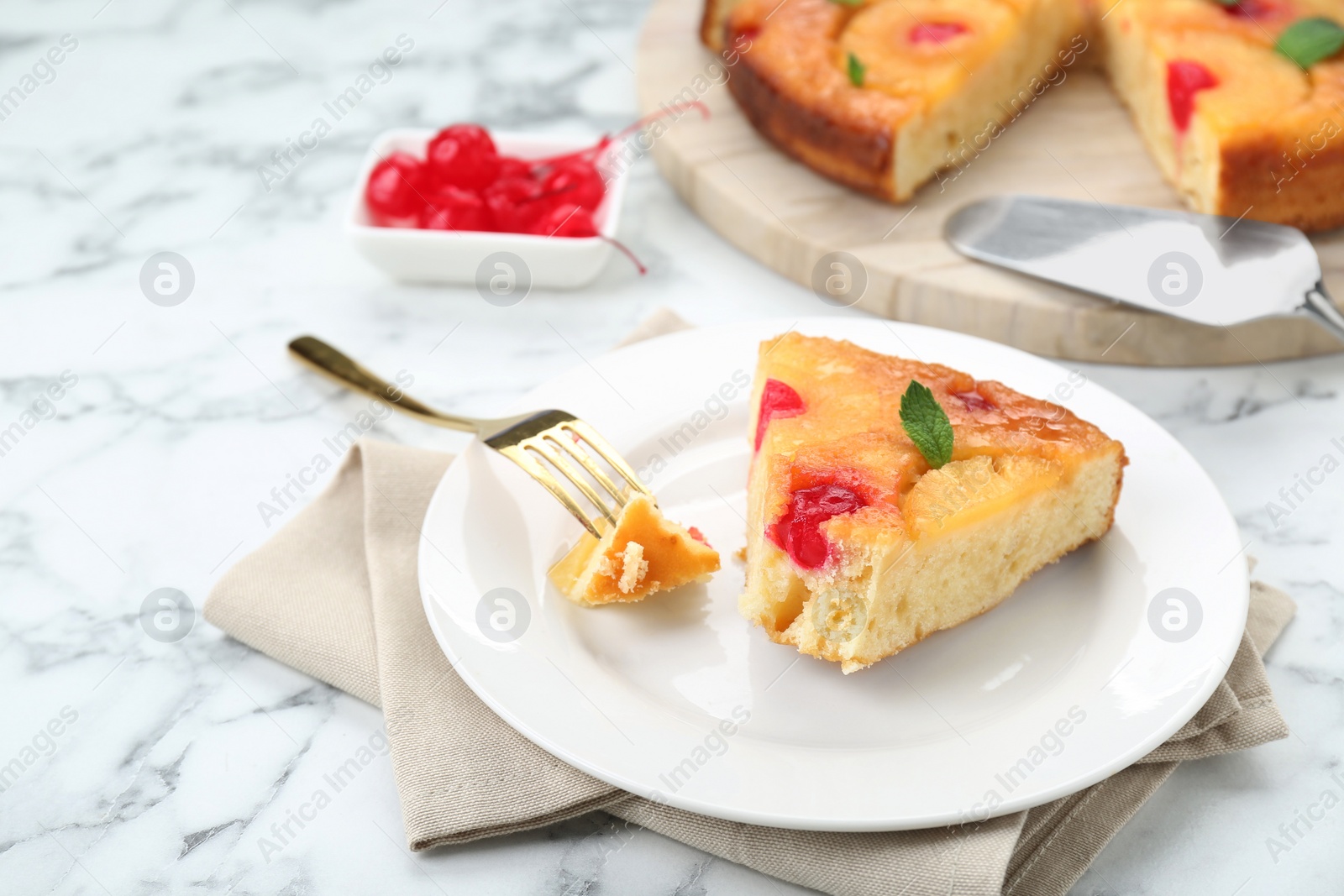 Photo of Eating piece of delicious pineapple pie with cherry and mint on white marble table